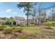 A large backyard features an expansive lawn and mature trees adding shade and privacy to the property at 108 White Oak Tl, Cumming, GA 30028
