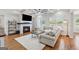 Cozy living room with a fireplace, coffered ceiling, large windows, and comfortable seating for relaxation and entertainment at 108 White Oak Tl, Cumming, GA 30028