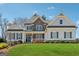 Charming two-story home features manicured lawn, stone accents, and a welcoming front porch at 108 White Oak Tl, Cumming, GA 30028