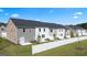Townhome backyards with white fences, manicured lawns and rear patios at 325 Silver Moon Dr, Loganville, GA 30052