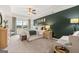 A main bedroom featuring a tray ceiling, a green accent wall, and plenty of natural light from the window at 325 Silver Moon Dr, Loganville, GA 30052