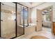 Bright bathroom with tiled shower, tub, and a view to the main bedroom at 1 Red Oak Trl, Sharpsburg, GA 30277