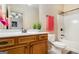 Neutral bathroom featuring a warm vanity, single sink, decorative plant, and a combined tub and shower at 1 Red Oak Trl, Sharpsburg, GA 30277