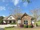 Attractive home with stone accents, mature trees, and a well-maintained lawn at 1 Red Oak Trl, Sharpsburg, GA 30277