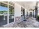 Inviting covered porch with stone flooring, ceiling fans, and elegant entry doors at 1 Red Oak Trl, Sharpsburg, GA 30277