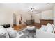 Bright upstairs living room with hardwood floors, neutral paint, ceiling fan, and a view to the staircase at 1 Red Oak Trl, Sharpsburg, GA 30277
