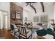 Cozy living room with a stone fireplace, high ceilings, and ample natural light at 1 Red Oak Trl, Sharpsburg, GA 30277