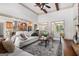 Open-concept living space featuring a stone fireplace and comfortable seating at 1 Red Oak Trl, Sharpsburg, GA 30277