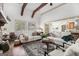 Bright living room with wood beams, large windows, and stylish furniture at 1 Red Oak Trl, Sharpsburg, GA 30277