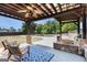 Outdoor patio featuring seating, an outdoor kitchen, a ceiling fan, and a view of the swimming pool and backyard at 1 Red Oak Trl, Sharpsburg, GA 30277