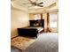 Spacious bedroom with natural light, carpet floors, a ceiling fan, and a tray ceiling at 1592 Smithson Ct, Lithonia, GA 30058