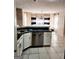 Open kitchen view showcasing stainless steel appliances, countertops, and tile floors at 1592 Smithson Ct, Lithonia, GA 30058