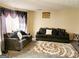 Cozy living room with plush seating, patterned rug, and natural light from large window at 1592 Smithson Ct, Lithonia, GA 30058