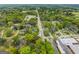 The aerial view showcases the tree-lined neighborhood with a mix of residential and commercial properties at 1202 Emory St, Oxford, GA 30054