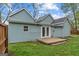 Backyard view showcasing light blue siding, a small deck, and a well-maintained lawn at 1202 Emory St, Oxford, GA 30054