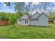 Spacious backyard featuring blue siding, a small deck, and a lush green lawn at 1202 Emory St, Oxford, GA 30054