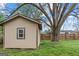 Backyard with a storage shed and a large shade tree on a well-maintained lawn at 1202 Emory St, Oxford, GA 30054