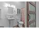 Bathroom featuring a pedestal sink, tiled wall, and a shower with a ruffled curtain at 1202 Emory St, Oxford, GA 30054