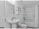 Bathroom with a pedestal sink, vanity, and a shower-tub combination at 1202 Emory St, Oxford, GA 30054