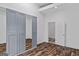 Bedroom with mirrored closet doors, wood-look floors, and a connecting door at 1202 Emory St, Oxford, GA 30054