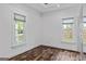 Bright bedroom with wood-look floors, windows, and built-in closet at 1202 Emory St, Oxford, GA 30054