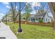 Inviting home with a spacious front yard and welcoming porch, framed by mature trees at 1202 Emory St, Oxford, GA 30054