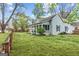 Charming home with a well-manicured lawn, inviting front porch, and blue siding at 1202 Emory St, Oxford, GA 30054