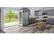 Updated kitchen with gray cabinets, stainless steel appliances, and large sliding doors to the deck at 1202 Emory St, Oxford, GA 30054