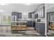 Modern kitchen with gray cabinets, stainless steel appliances, and a functional kitchen island at 1202 Emory St, Oxford, GA 30054