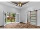 Comfortable living room featuring an outdoor deck and trendy sliding barn door at 1202 Emory St, Oxford, GA 30054
