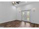 Bright living room boasts wood-look flooring, modern lighting, and glass doors to the outside at 1202 Emory St, Oxford, GA 30054