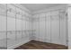 Spacious walk-in closet features custom white shelving and rod system for optimal storage at 1202 Emory St, Oxford, GA 30054