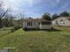 This backyard has a white exterior and an enclosed porch area at 1243 Hill Nw St, Conyers, GA 30012