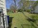 This backyard has a red storage shed and a chain link fence at 1243 Hill Nw St, Conyers, GA 30012