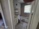 The vintage bathroom with tiled walls features a sink vanity and a standard tub at 1243 Hill Nw St, Conyers, GA 30012