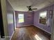 Bedroom with lilac walls, two windows, a ceiling fan, and hardwood floors at 1243 Hill Nw St, Conyers, GA 30012