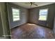 This bedroom offers natural light from two windows and original hardwood floors at 1243 Hill Nw St, Conyers, GA 30012