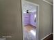 This bedroom is painted in a light purple with hardwood floors and one window at 1243 Hill Nw St, Conyers, GA 30012