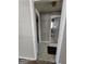 Hallway view showcasing the tile flooring and entrances to the bathroom and another room at 1243 Hill Nw St, Conyers, GA 30012