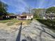 Exterior of a one-story home with a red awning and an overgrown yard at 1243 Hill Nw St, Conyers, GA 30012