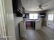 A kitchen with cabinets, gas oven, and tile flooring, showing the potential for renovation at 1243 Hill Nw St, Conyers, GA 30012