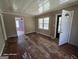 Open living room with two windows, access to front door, and doorway to purple bedroom at 1243 Hill Nw St, Conyers, GA 30012