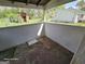 This covered porch has painted wood walls and a view of the yard at 1243 Hill Nw St, Conyers, GA 30012