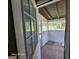 This covered porch has painted wood walls and a view of the yard at 1243 Hill Nw St, Conyers, GA 30012