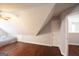This attic has hardwood floors, a ceiling fan, and a door to the hallway at 75 Prestwick Ln, Peachtree City, GA 30269