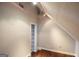 Finished attic with shelving unit and track lighting at 75 Prestwick Ln, Peachtree City, GA 30269