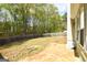 View of fenced backyard with a stone patio at 75 Prestwick Ln, Peachtree City, GA 30269