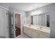 Bathroom with double sinks, vanity with cabinets, and black and white tile floors at 75 Prestwick Ln, Peachtree City, GA 30269
