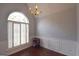 Dining room with chandelier, large window, wainscoting, and hardwood floors at 75 Prestwick Ln, Peachtree City, GA 30269