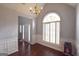 Bright dining room with chandelier, wainscoting, large windows, and hardwood floors at 75 Prestwick Ln, Peachtree City, GA 30269